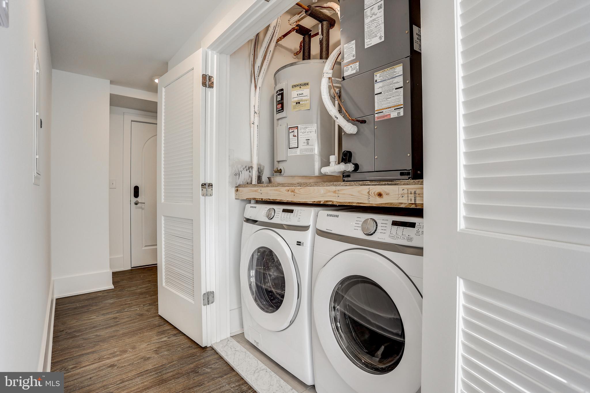 5959-63 Ridge Avenue, Unit 1BED/1BATH Philadelphia, PA 19128 - Photo 8 of 32 a view of a hallway with washer and dryer