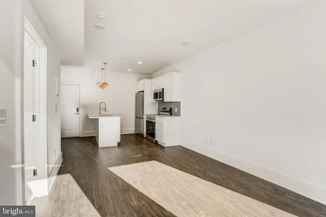 a view of a kitchen with wooden floor