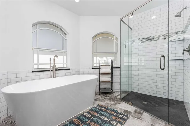 a bathroom with a bathtub and a shower