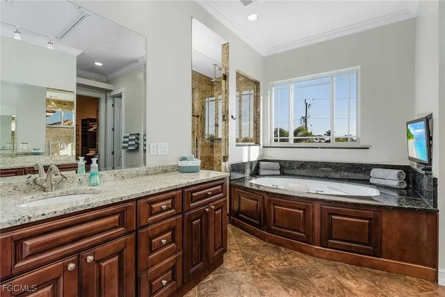 a spacious bathroom with a granite countertop double vanity sink and a mirror