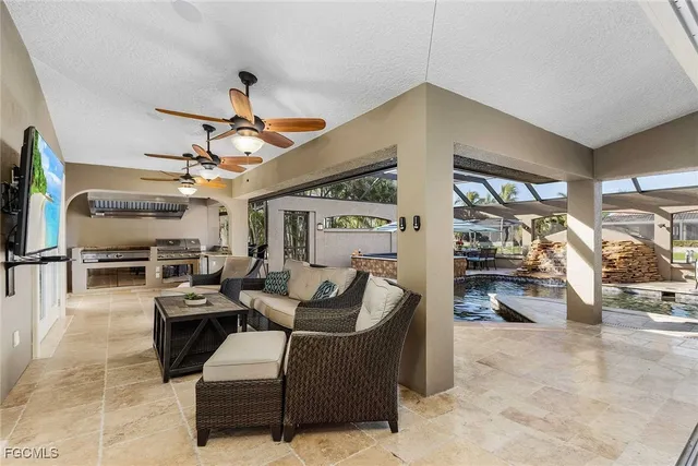 a living room with furniture kitchen view and a large window