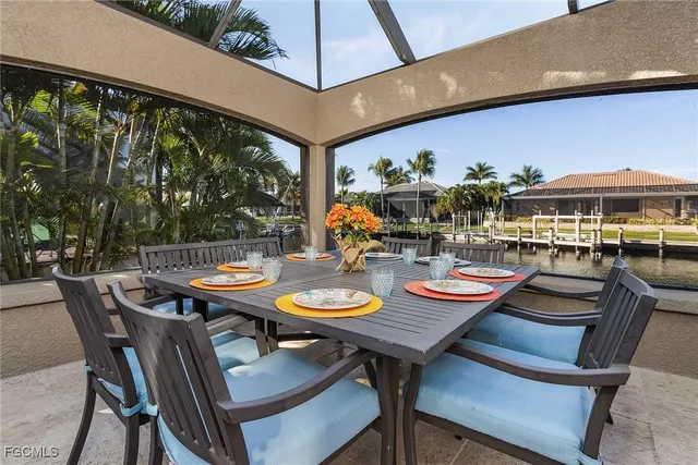 a outdoor dining space with furniture and umbrella