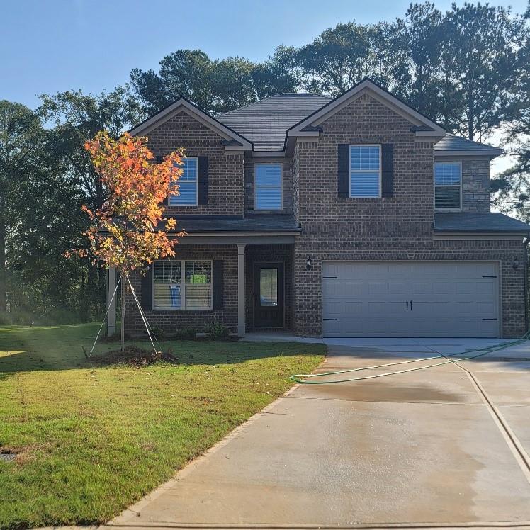 a front view of a house with a yard