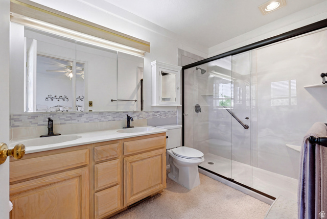 3766 Cardiff Circle Bountiful, UT 84010 - Photo 26 of 46 Bathroom featuring a dual vanity with light wood cabinetry, white countertops, and black fixtures