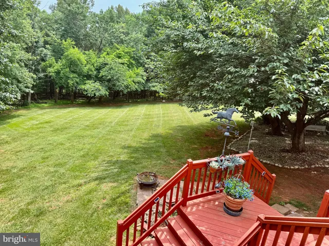 a living room with furniture a rug and a large window
