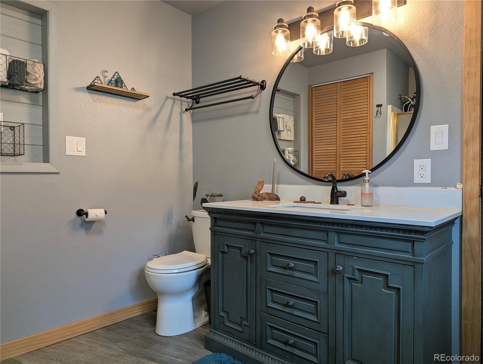 2084 Forbes Park Road Fort Garland, CO 81133 - Photo 28 of 39 a bathroom with a toilet a sink and mirror