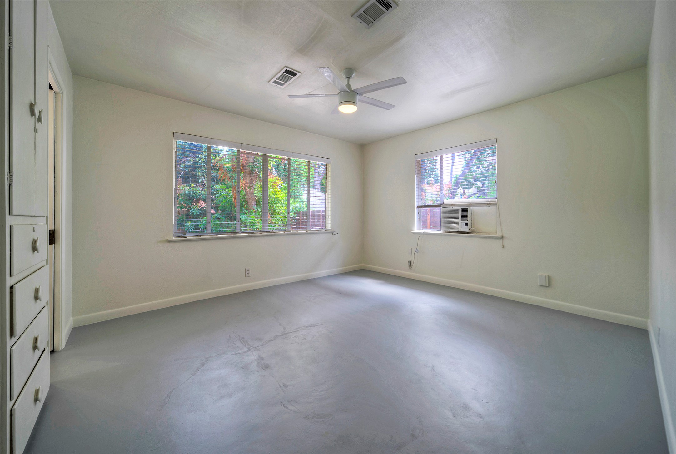 1803 Pearl Street Austin, TX 78701 - Photo 11 of 33 en empty room with windows ceiling fan and windows