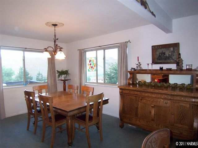 20710 Cooke Drive Reno, NV 89521 - Photo 3 of 13 a dining room with furniture a chandelier and window