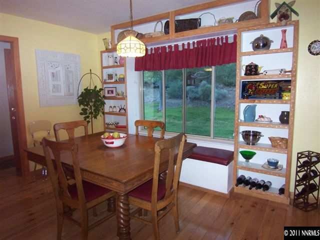 20710 Cooke Drive Reno, NV 89521 - Photo 5 of 13 a view of a dining room with furniture large windows and wooden floor