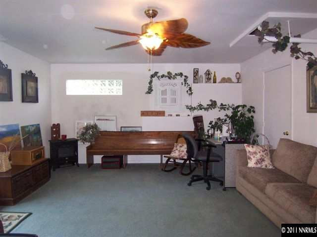 20710 Cooke Drive Reno, NV 89521 - Photo 8 of 13 a living room with furniture and a chandelier