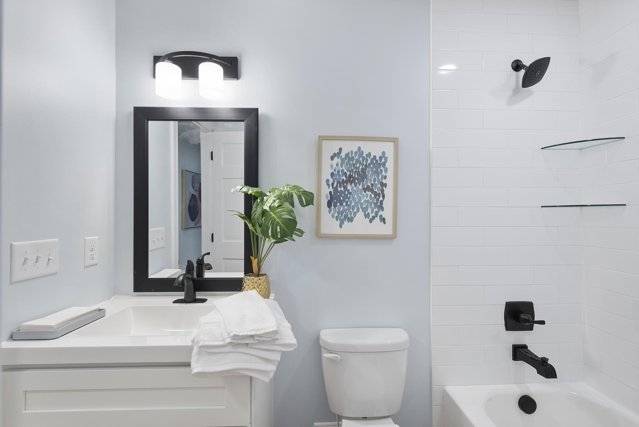 6908 Fernhill Lane Raleigh, NC 27612 - Photo 15 of 24 a bathroom with a toilet a sink and a mirror