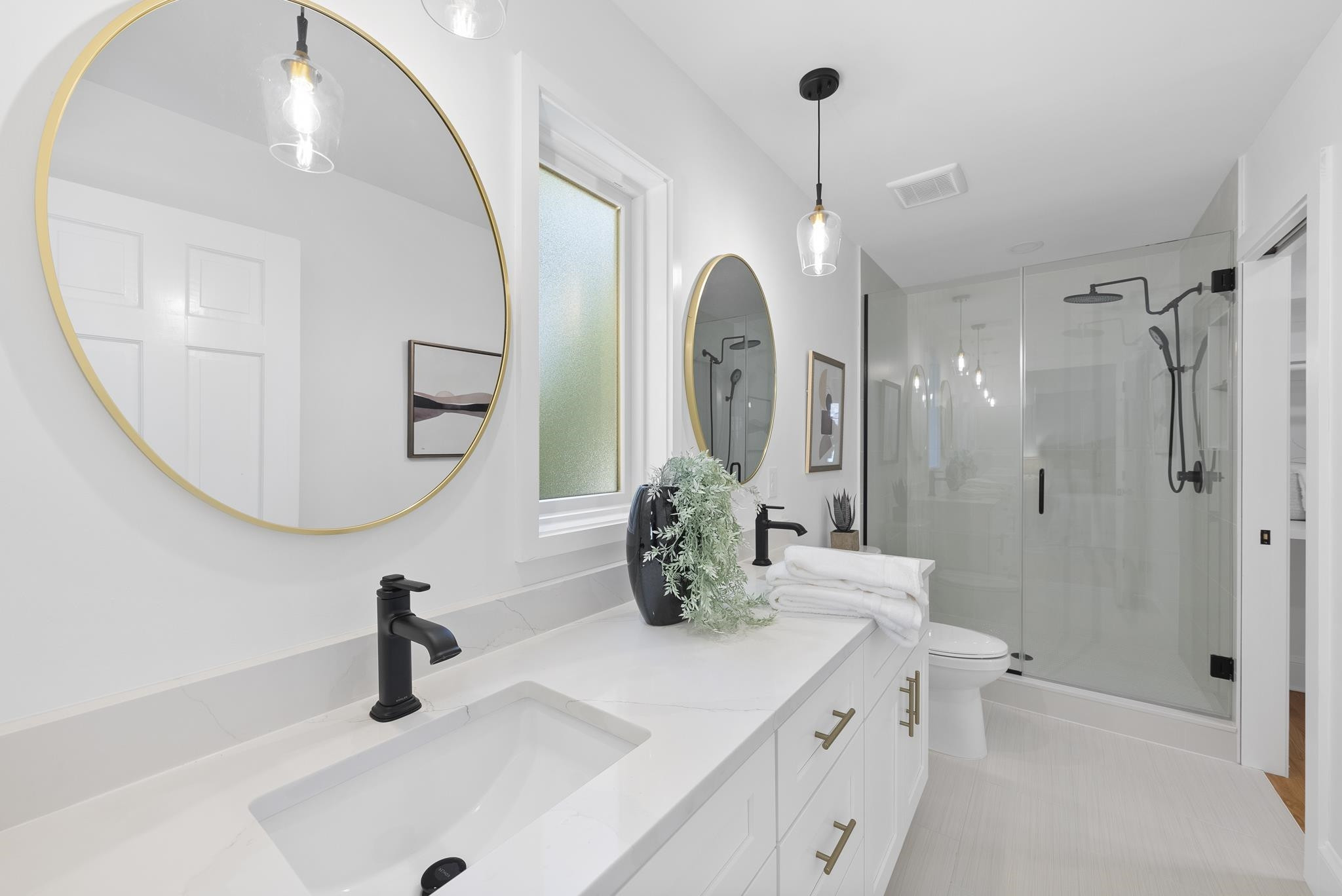 6908 Fernhill Lane Raleigh, NC 27612 - Photo 17 of 24 a bathroom with a double vanity sink and a mirror