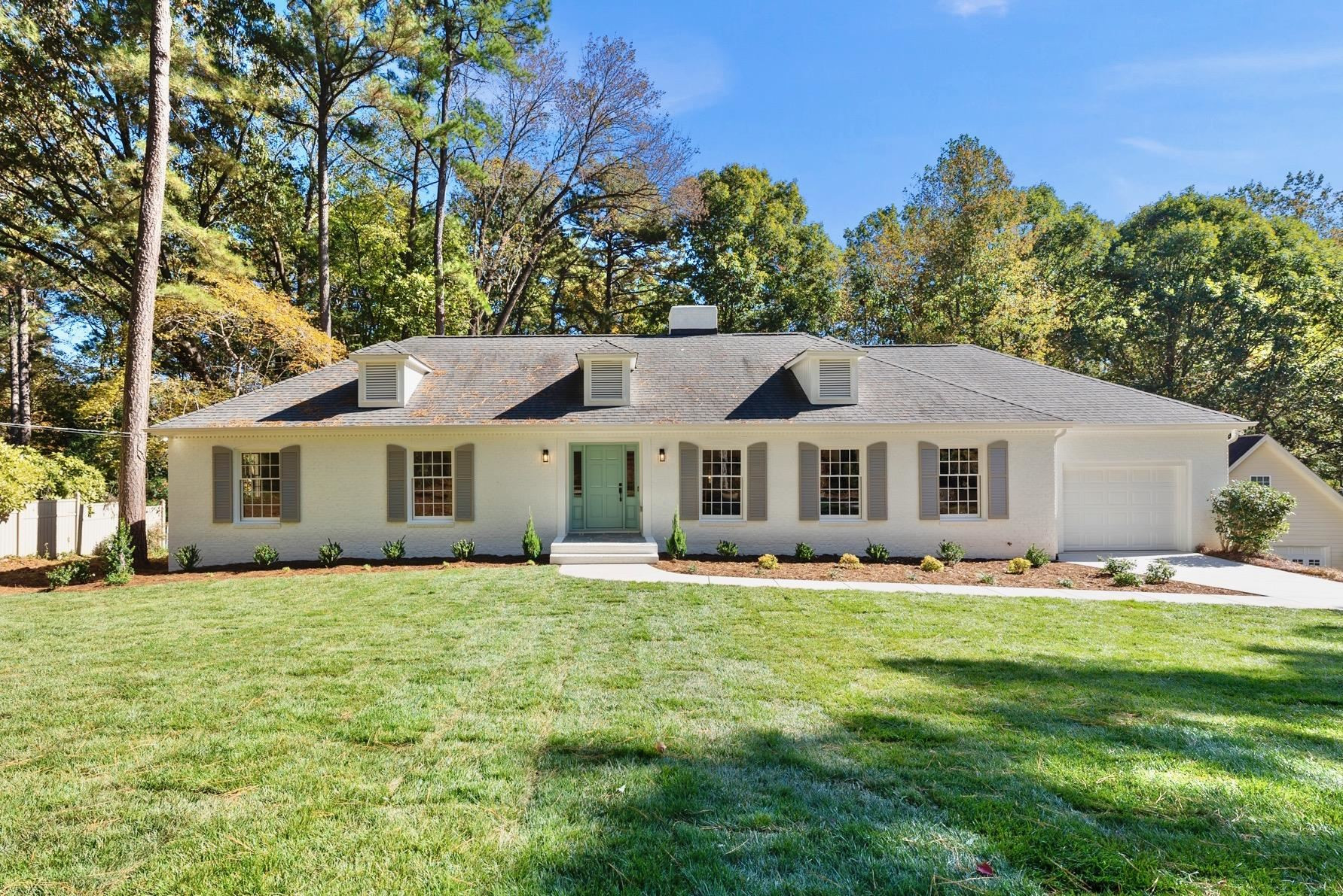 6908 Fernhill Lane Raleigh, NC 27612 - Photo 2 of 24 a front view of a house with a garden