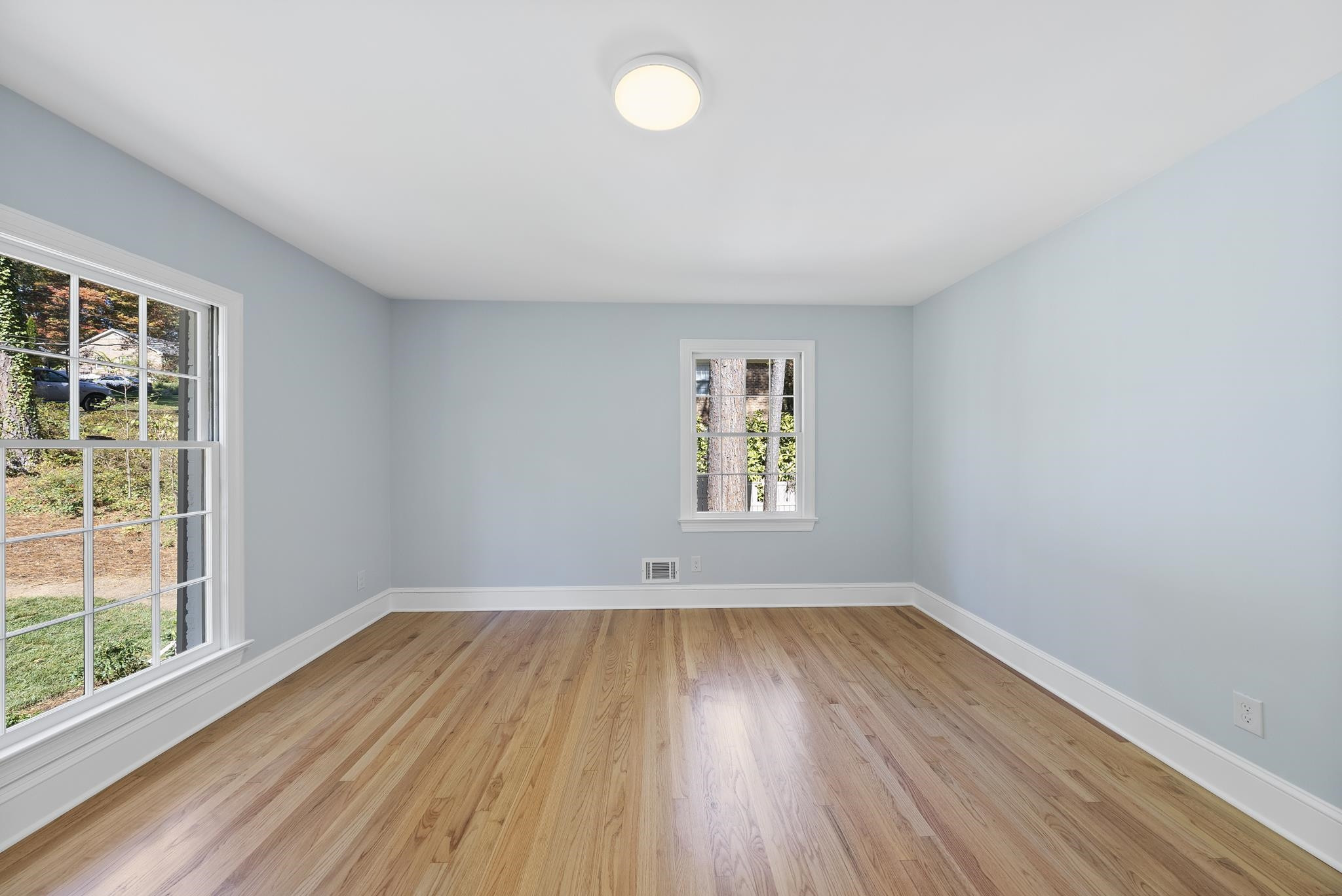 6908 Fernhill Lane Raleigh, NC 27612 - Photo 21 of 24 an empty room with wooden floor and windows