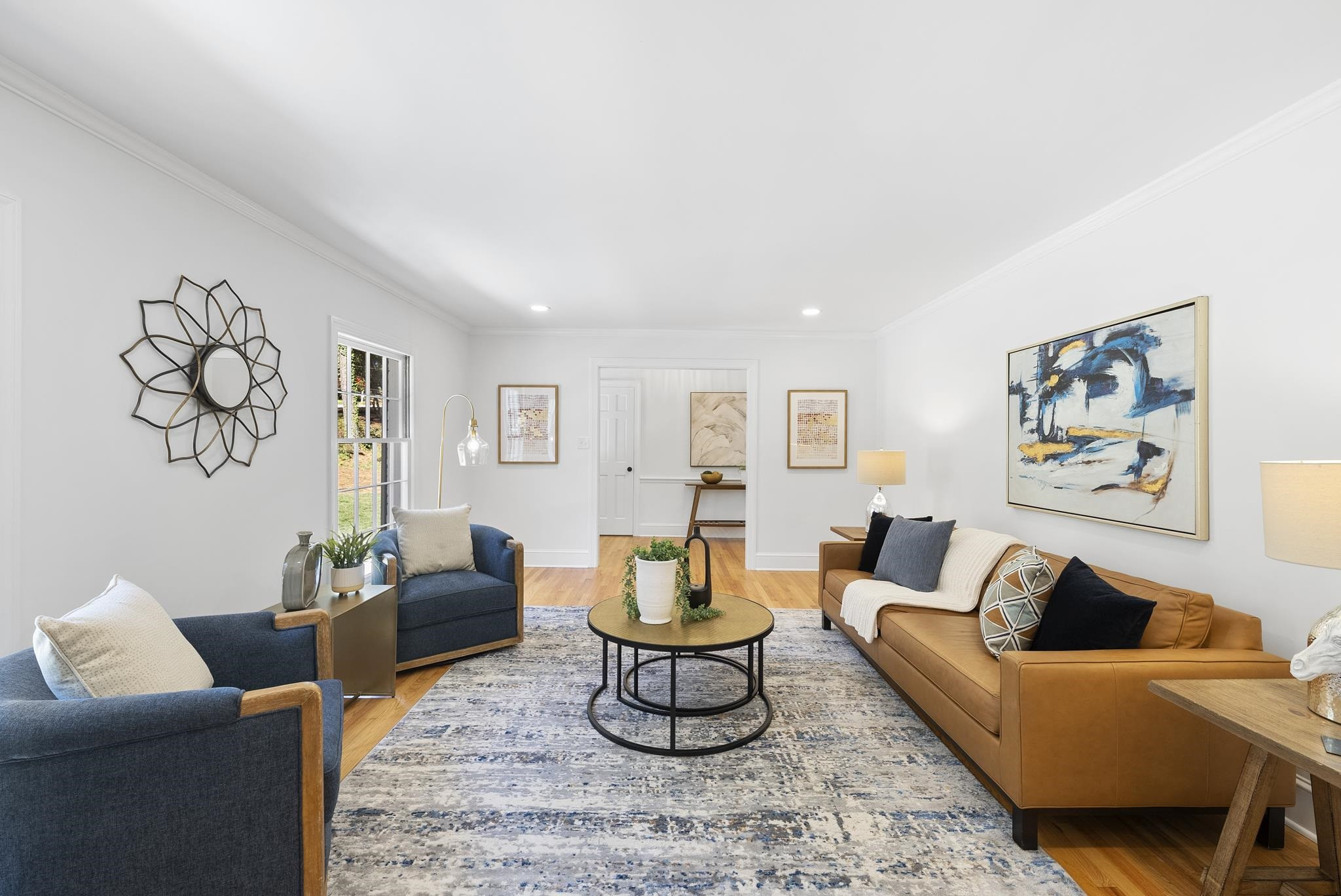 6908 Fernhill Lane Raleigh, NC 27612 - Photo 4 of 24 a living room with furniture a rug and wall paintings
