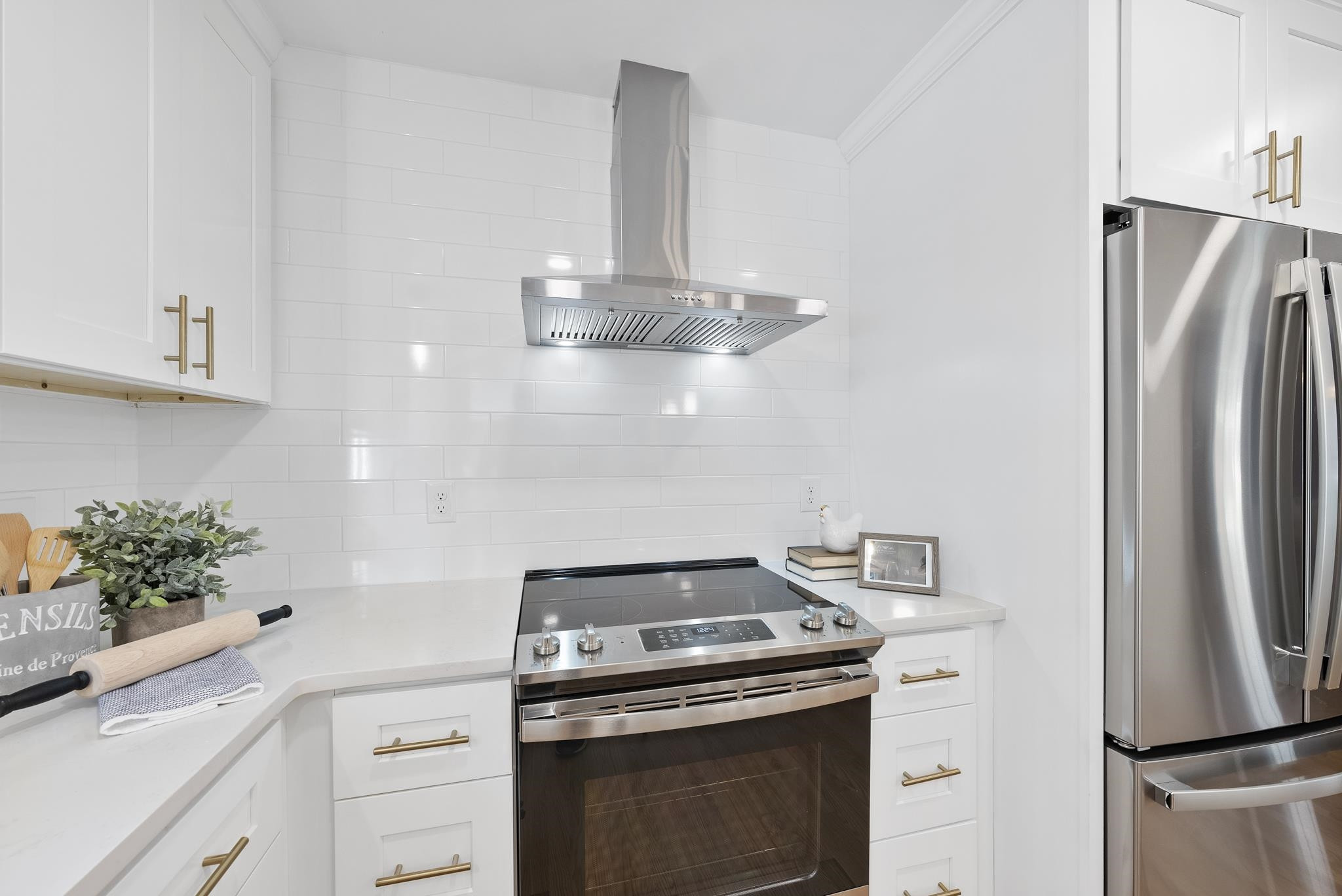 6908 Fernhill Lane Raleigh, NC 27612 - Photo 10 of 24 a kitchen with stainless steel appliances a stove a refrigerator and cabinets