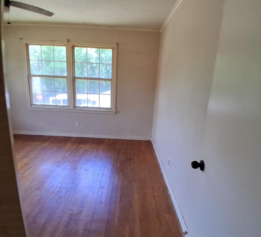 910 Success Street Gilmer, TX 75644 - Photo 13 of 20 a view of a room with wooden floor and window