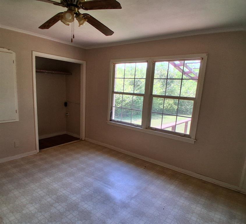 910 Success Street Gilmer, TX 75644 - Photo 6 of 20 a view of an empty room with a window