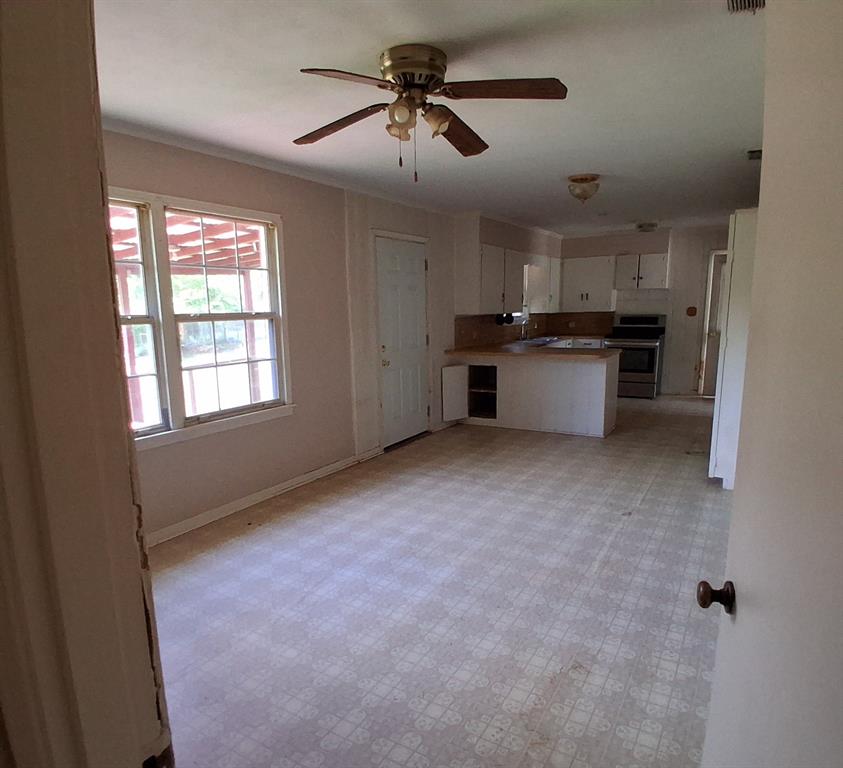 910 Success Street Gilmer, TX 75644 - Photo 7 of 20 a view of a kitchen with a sink cabinets and a window