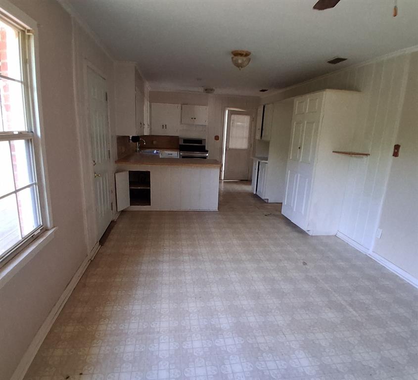 910 Success Street Gilmer, TX 75644 - Photo 8 of 20 a view of a kitchen with refrigerator and windows