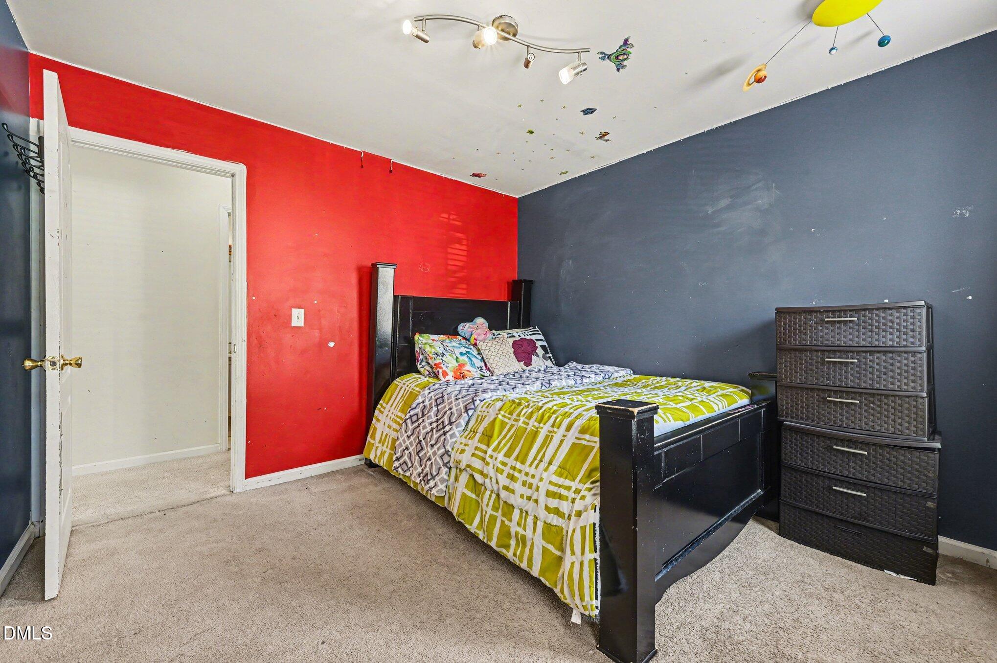 5115 Cardinal Grove Boulevard Raleigh, NC 27616 - Photo 16 of 36 a bedroom with a bed and a dresser