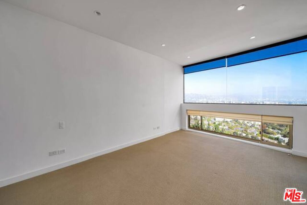 2220 Avenue Of The Stars, Unit 2004W Los Angeles, CA 90067 - Photo 20 of 25 a view of an empty room with a floor to ceiling window