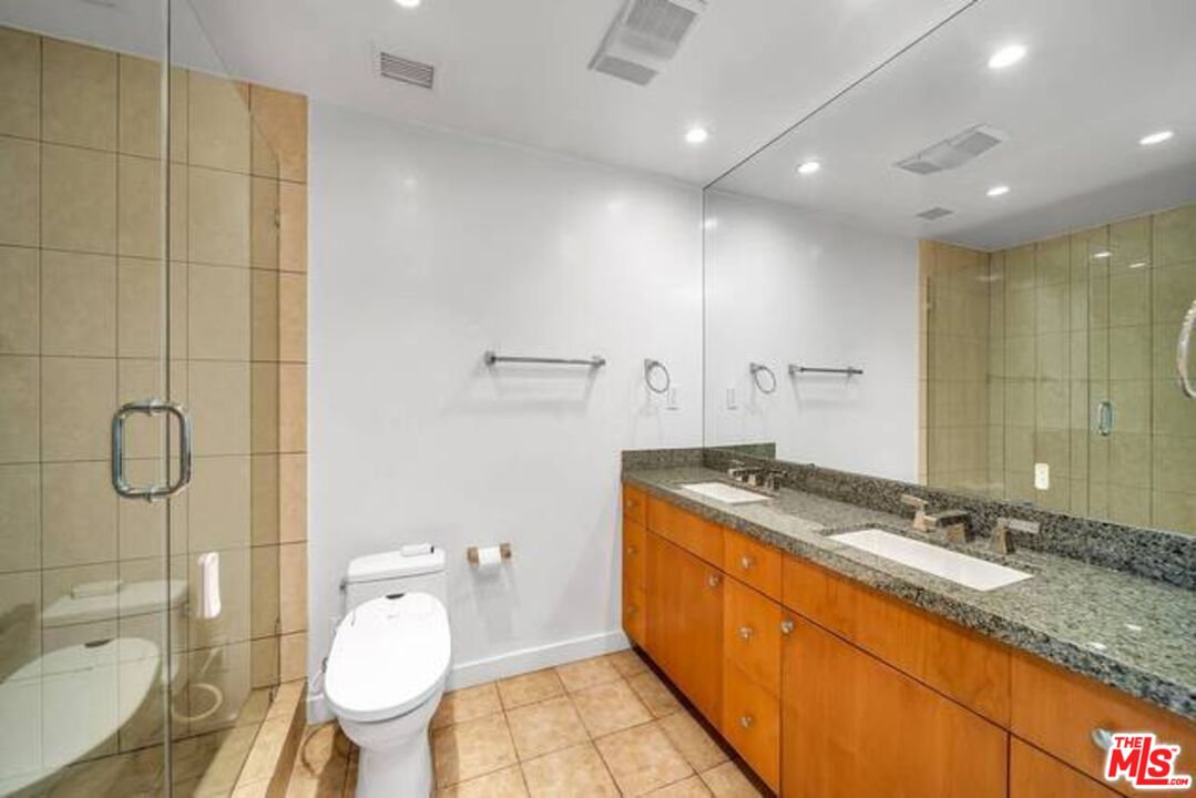 2220 Avenue Of The Stars, Unit 2004W Los Angeles, CA 90067 - Photo 25 of 25 a bathroom with a granite countertop sink toilet mirror vanity and shower