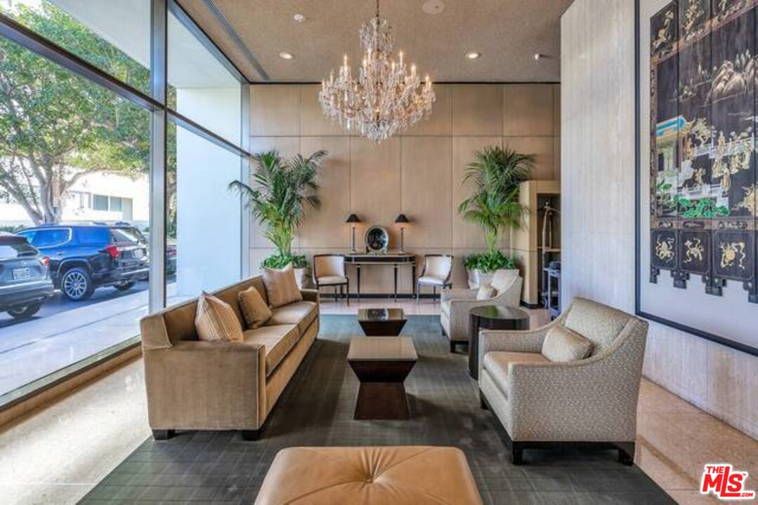 2220 Avenue Of The Stars, Unit 2004W Los Angeles, CA 90067 - Photo 4 of 25 a living room with furniture a chandelier and a large mirror