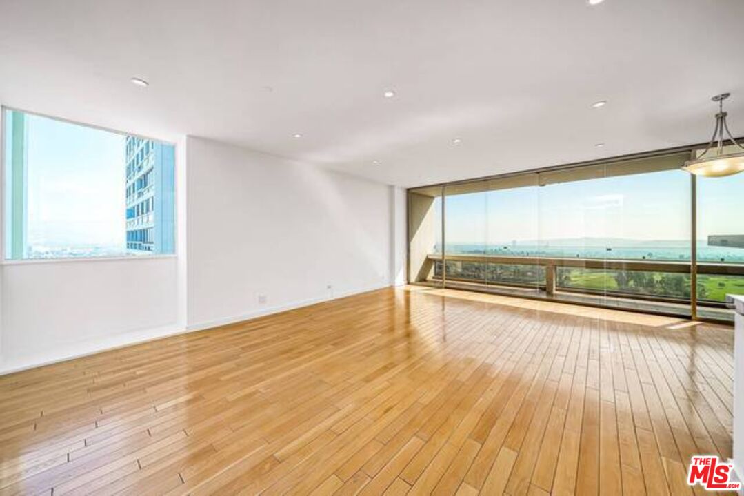 2220 Avenue Of The Stars, Unit 2004W Los Angeles, CA 90067 - Photo 6 of 25 an empty room with wooden floor and windows