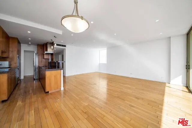 a large kitchen with stainless steel appliances granite countertop a lot of counter space and a sink