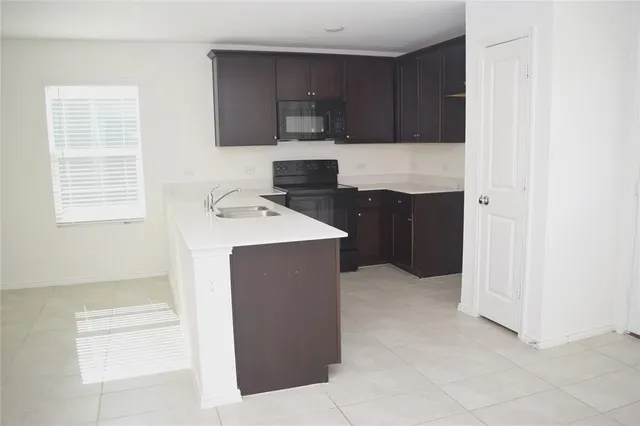 a kitchen with a cabinets and white appliances