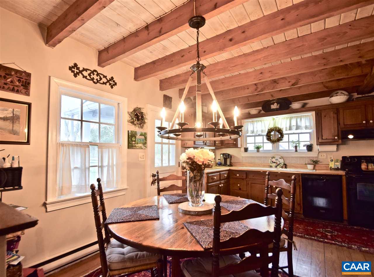 237 Campbell Road Keswick, VA 22947 - Photo 8 of 41 a dining room with stainless steel appliances granite countertop a dining table and chairs with wooden floor