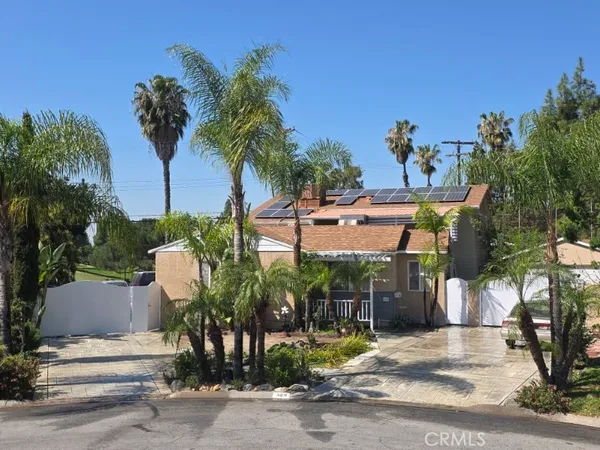 a view of street along with house and trees