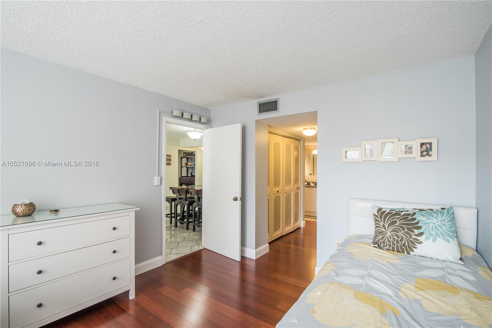 1665 Bay Road, Unit 425 Miami Beach, FL 33139 - Photo 11 of 15 a bedroom with a bed and a dresser
