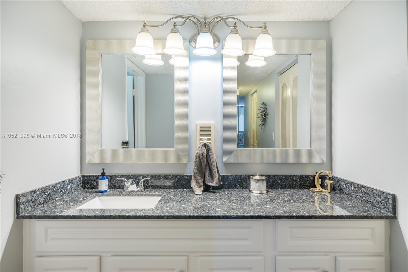 1665 Bay Road, Unit 425 Miami Beach, FL 33139 - Photo 13 of 15 a bathroom with a double vanity sink and a mirror