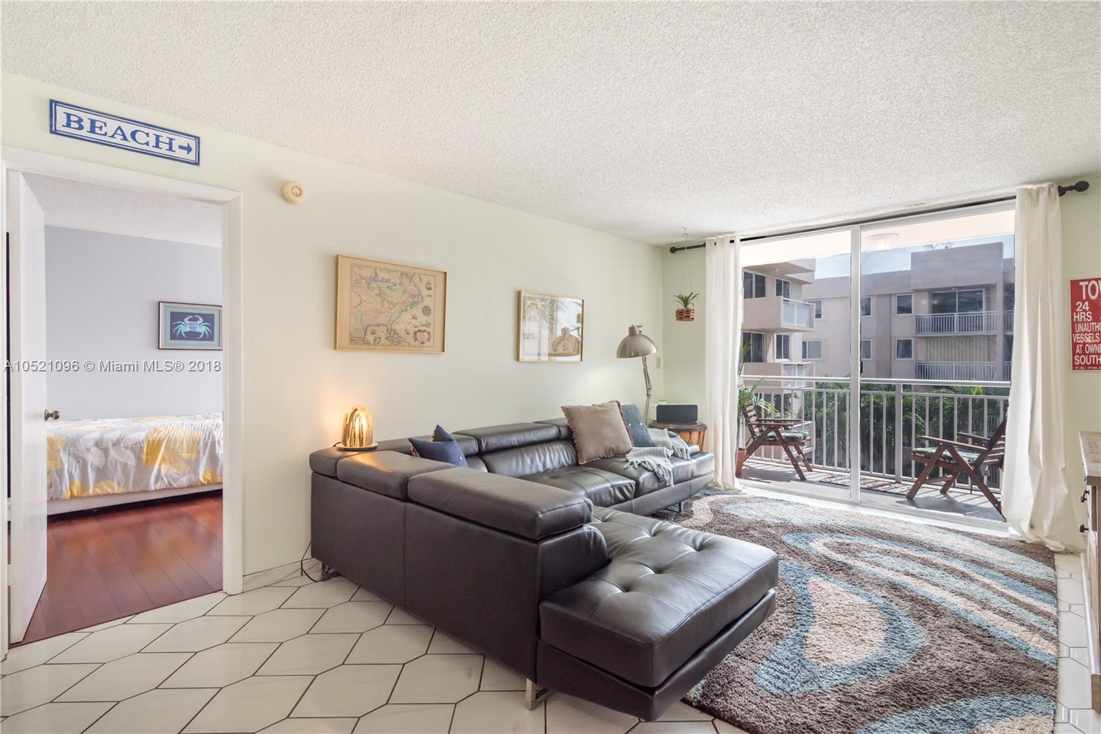 1665 Bay Road, Unit 425 Miami Beach, FL 33139 - Photo 8 of 15 a living room with furniture and a rug