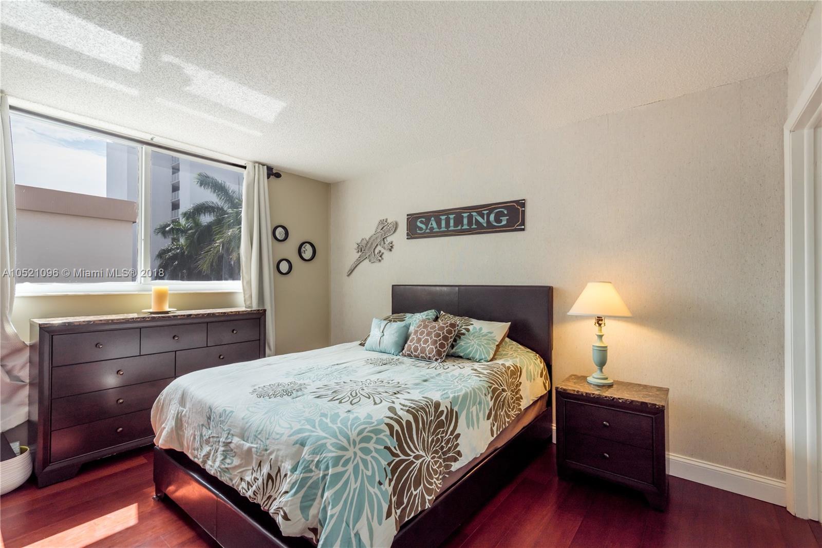 1665 Bay Road, Unit 425 Miami Beach, FL 33139 - Photo 9 of 15 a bedroom with a bed and a window