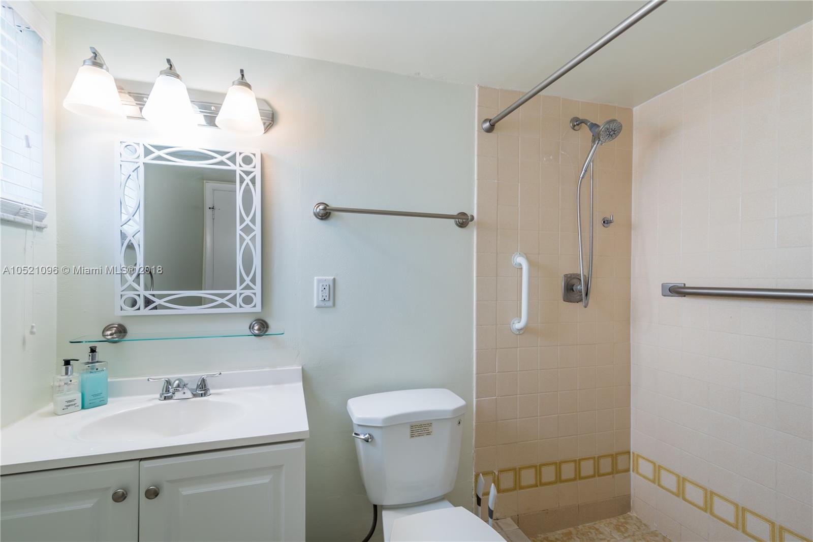 1665 Bay Road, Unit 425 Miami Beach, FL 33139 - Photo 10 of 15 a bathroom with a sink toilet vanity and shower