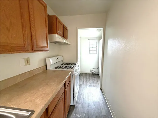 a kitchen with a stove a sink and a refrigerator