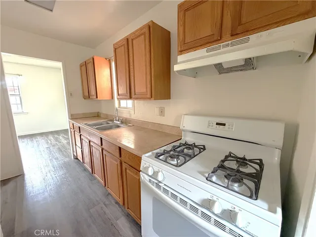a kitchen with a stove and a refrigerator
