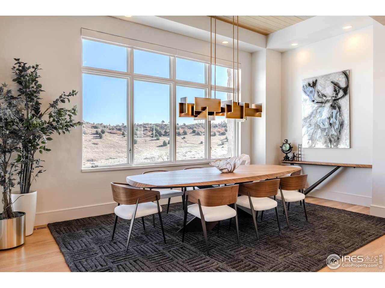 7572 Raphael Lane Littleton, CO 80125 - Photo 12 of 50 Open yet defined, the dining area occupies a glass-wrapped corner overlooking the golf course and mountains. Tongue-and-groove ceiling detailing adds texture and intimacy, while the generous proportions easily accommodate celebrations of scale.