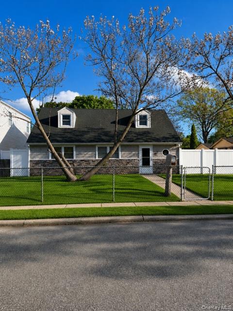 700 Sharon Road Copiague, NY 11726 - Photo 1 of 27 a front view of a house with a yard
