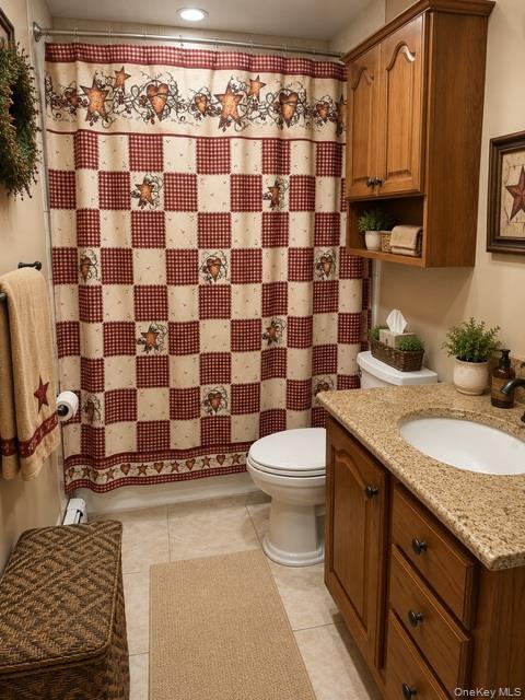 700 Sharon Road Copiague, NY 11726 - Photo 15 of 27 a bathroom with a granite countertop toilet a sink and a mirror