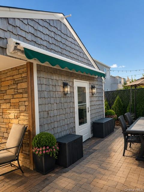700 Sharon Road Copiague, NY 11726 - Photo 16 of 27 a front view of a house with outdoor seating