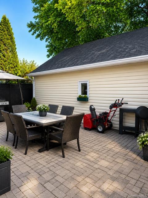 700 Sharon Road Copiague, NY 11726 - Photo 17 of 27 a view of a patio with table and chairs and potted plants