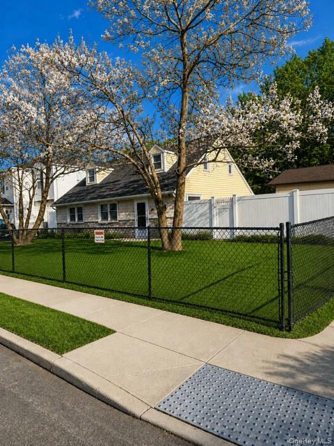 700 Sharon Road Copiague, NY 11726 - Photo 2 of 27 a house with tree in the background