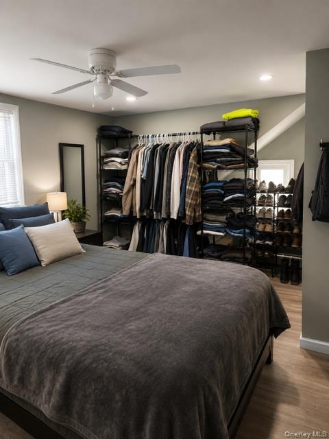 700 Sharon Road Copiague, NY 11726 - Photo 27 of 27 a bedroom with a bed and a walk in closet