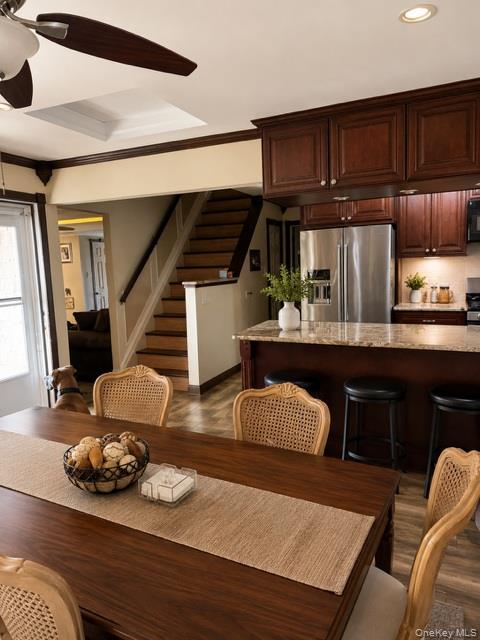700 Sharon Road Copiague, NY 11726 - Photo 6 of 27 a kitchen with a table chairs and a stove