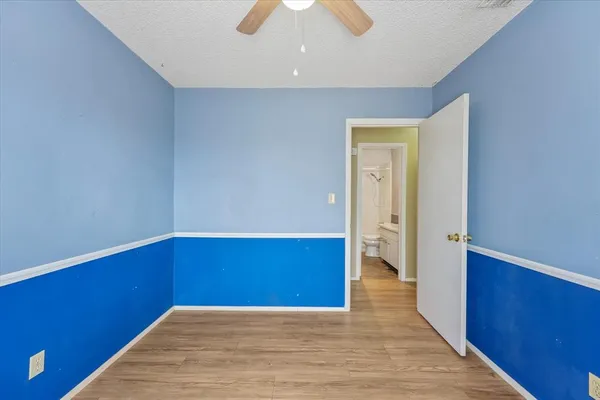 a view of empty room with wooden floor and window