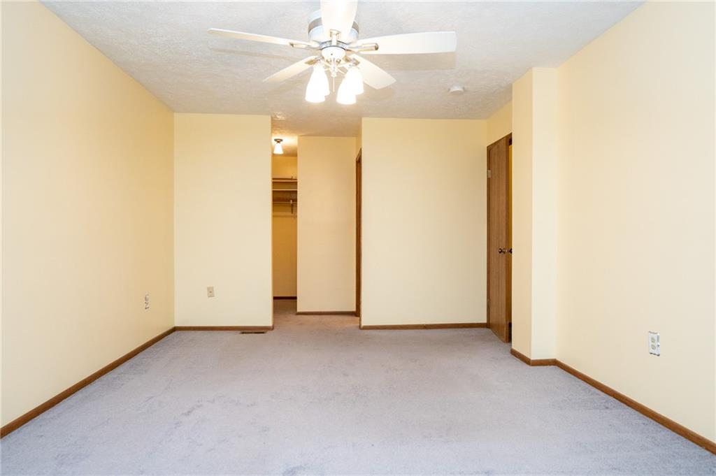 7324 Green Meadow Drive Imperial, PA 15126 - Photo 12 of 43 an empty room with a ceiling fan and a window